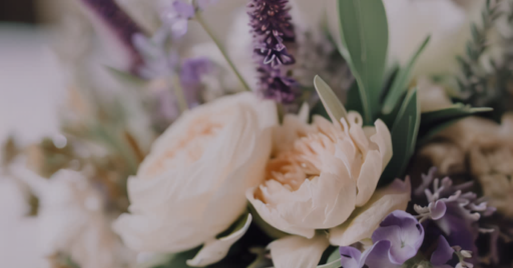 Dreamy lavender and earthy sage floral centerpiece for an August wedding