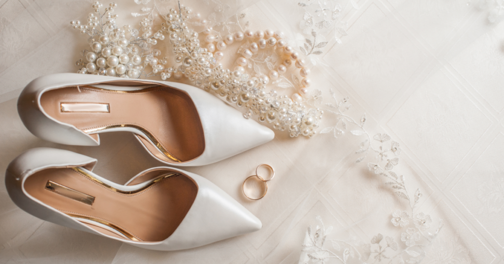 Collection of wedding accessories, including shoes, jewelry, veils, and hairpieces, coordinated with a dress.